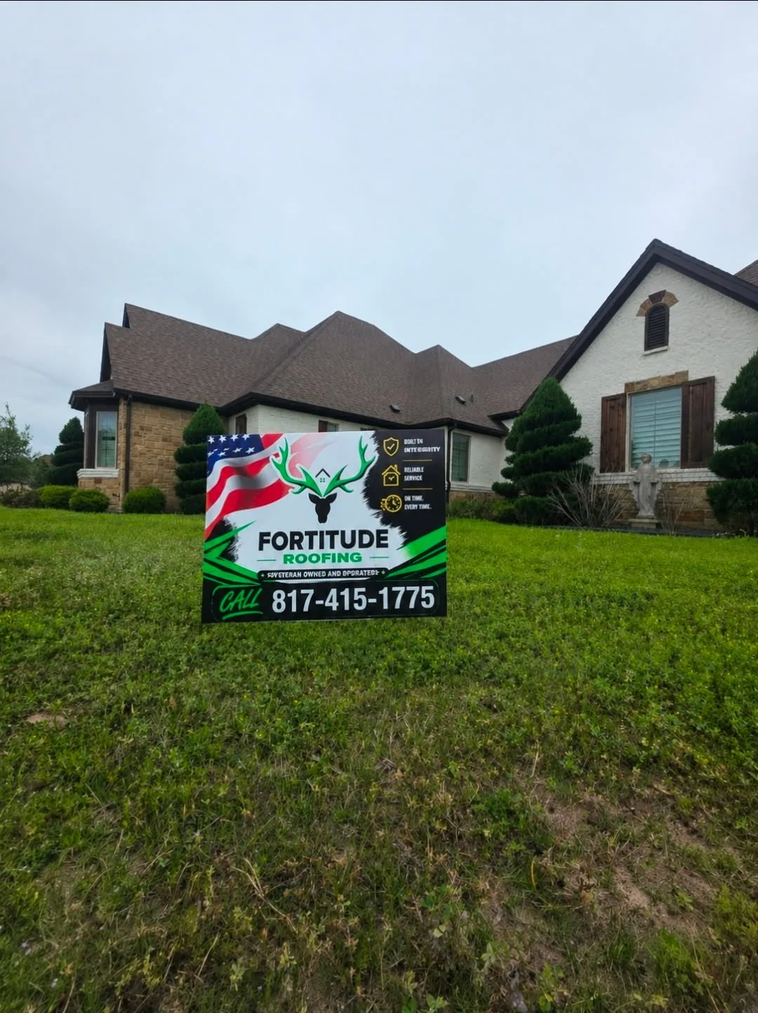 Fortitude Roofing yard sign in front of a completed home